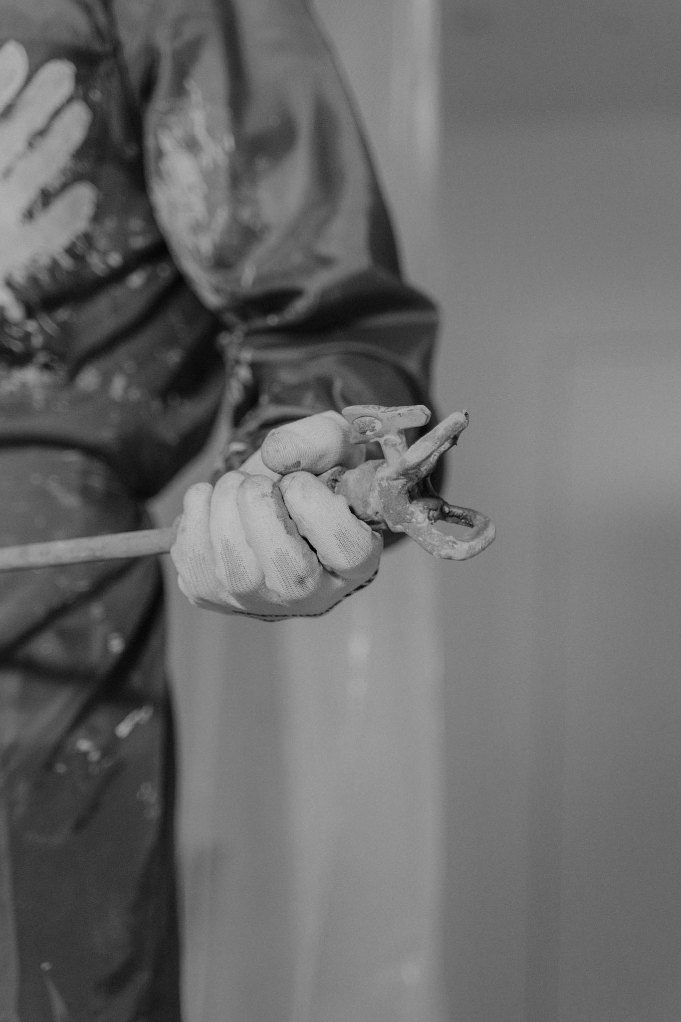 Monochrome Photo Featuring A Workers Hand Gripping